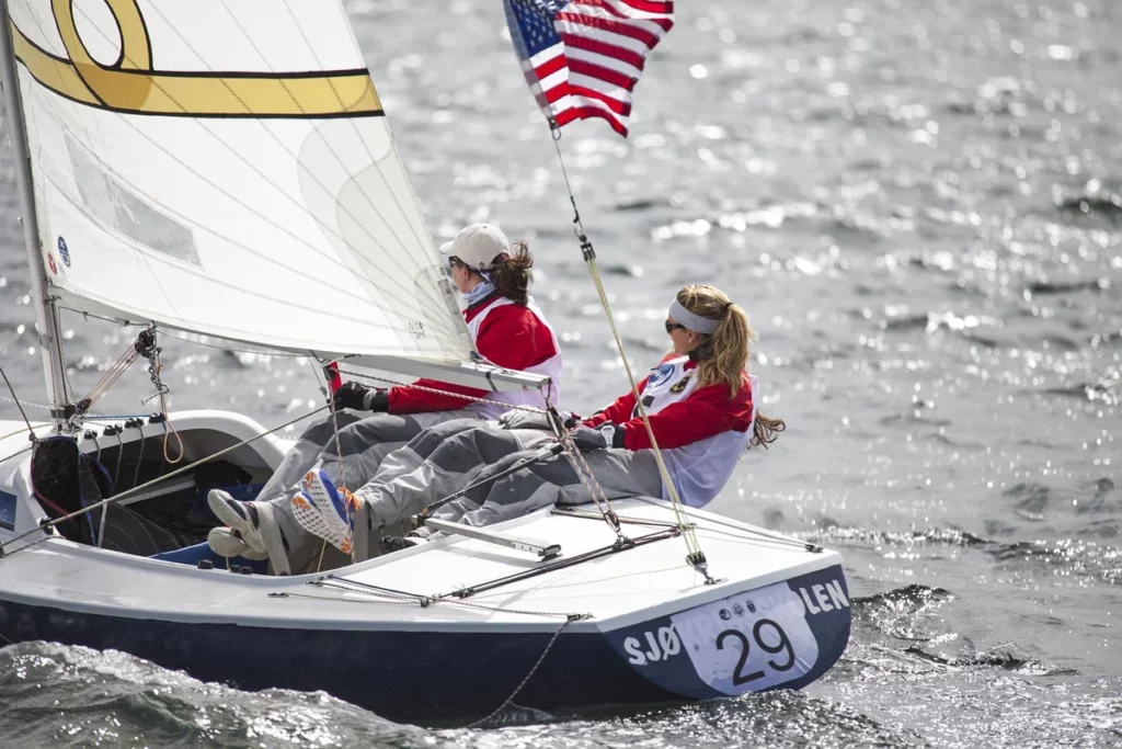 Sailing boat with two crew members participating in the sailboat racing