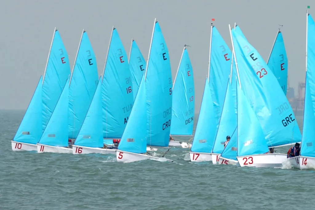 Sailboat Racing of the same class maneuvering near the start line