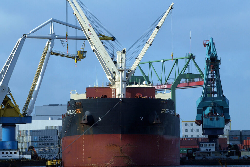 Ultramax bulk carrier discharging in port