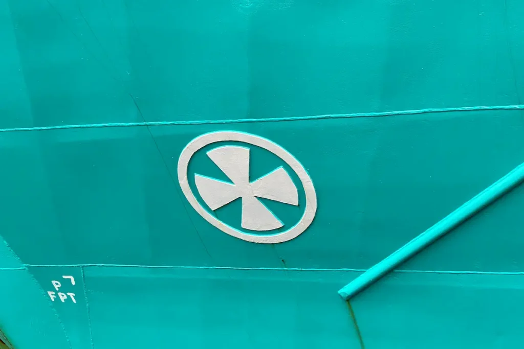 Image of a bow thruster marking, represented by a circle with an 'X' inside, indicating the location of a bow thruster on the ship.