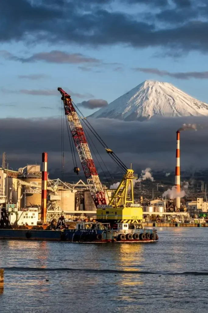 Clamshell Dredger in Tagonoura port with the view on mount Fuji