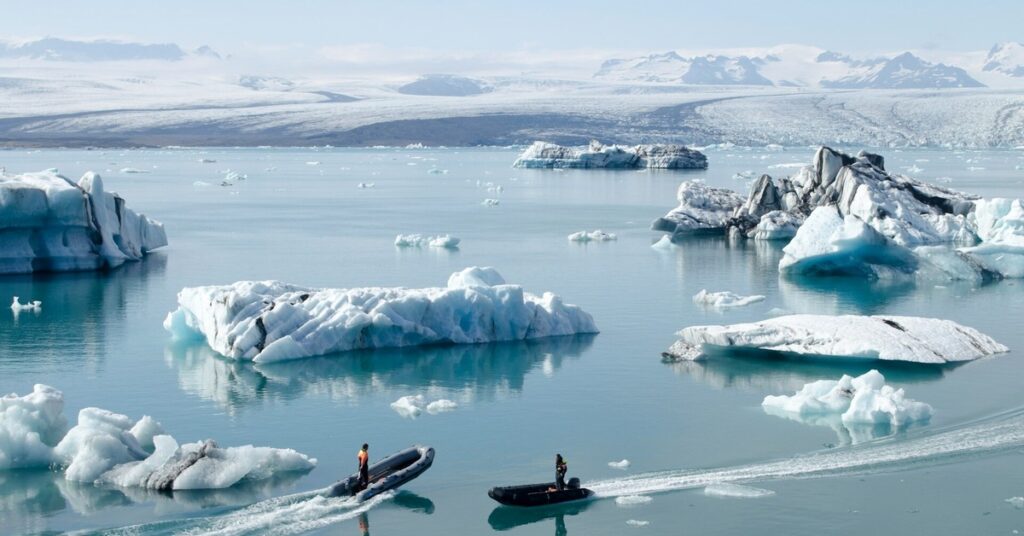 two boats surrounded by broken glaciers