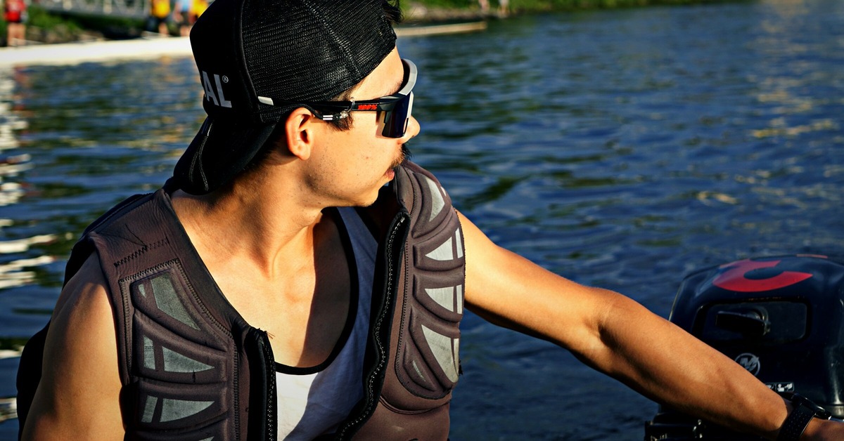 A young man driving a boat